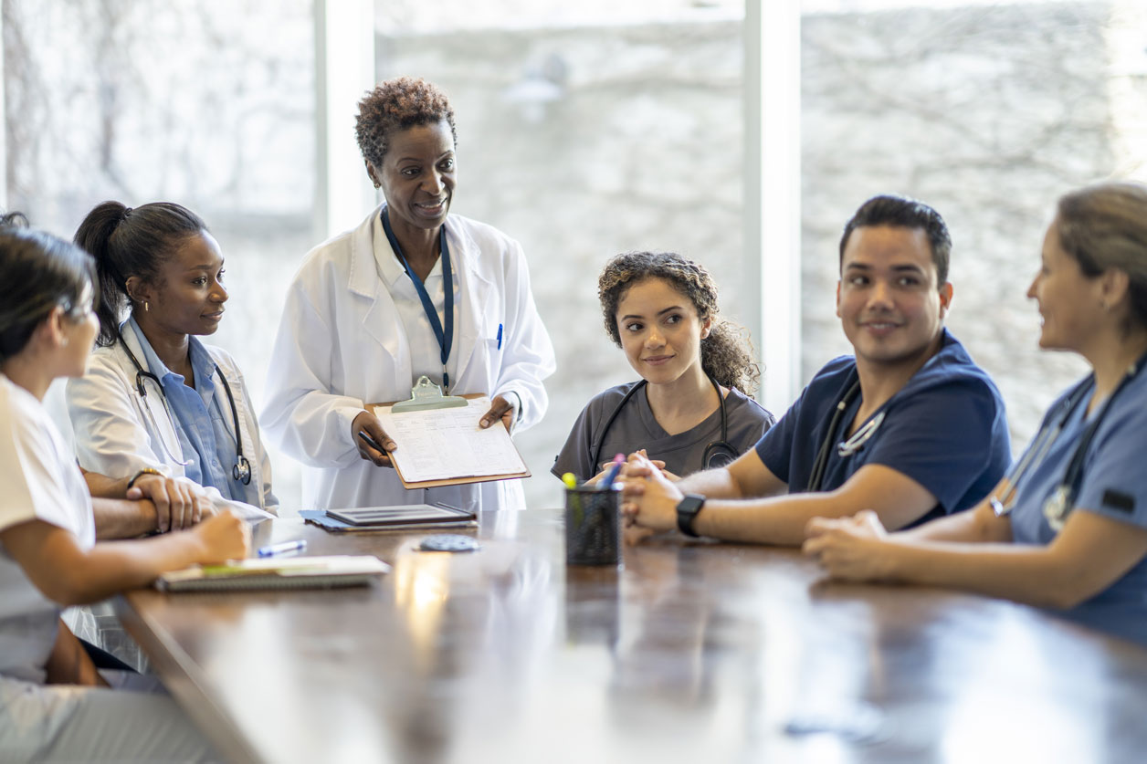 Doctors and nurses in discussion around a table