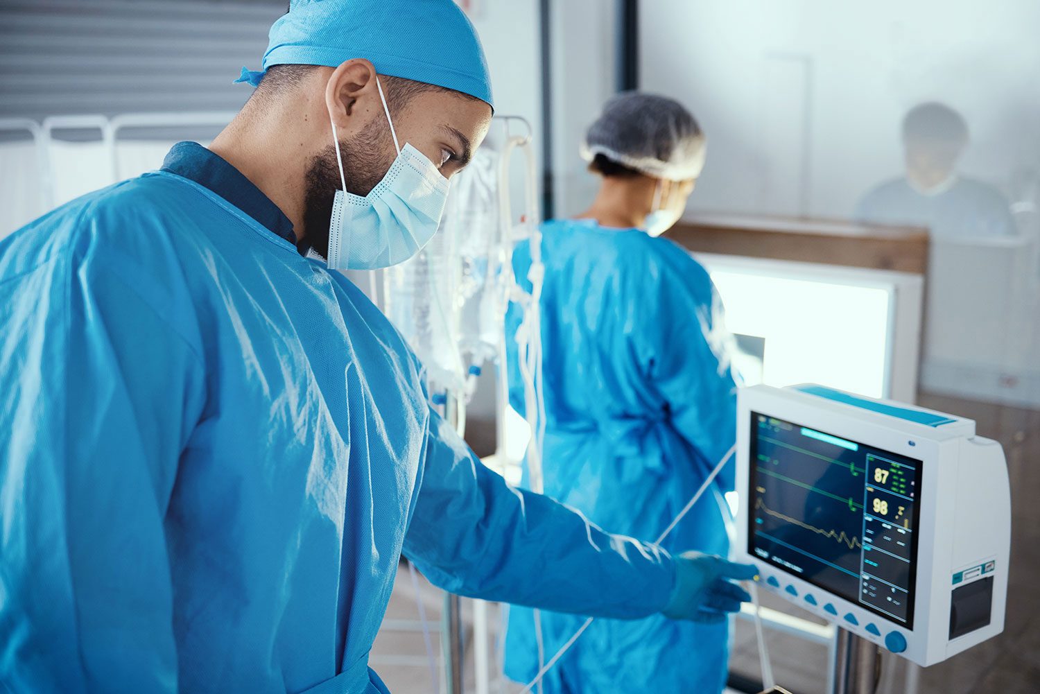 Hospital workers assessing electronic graph equipment