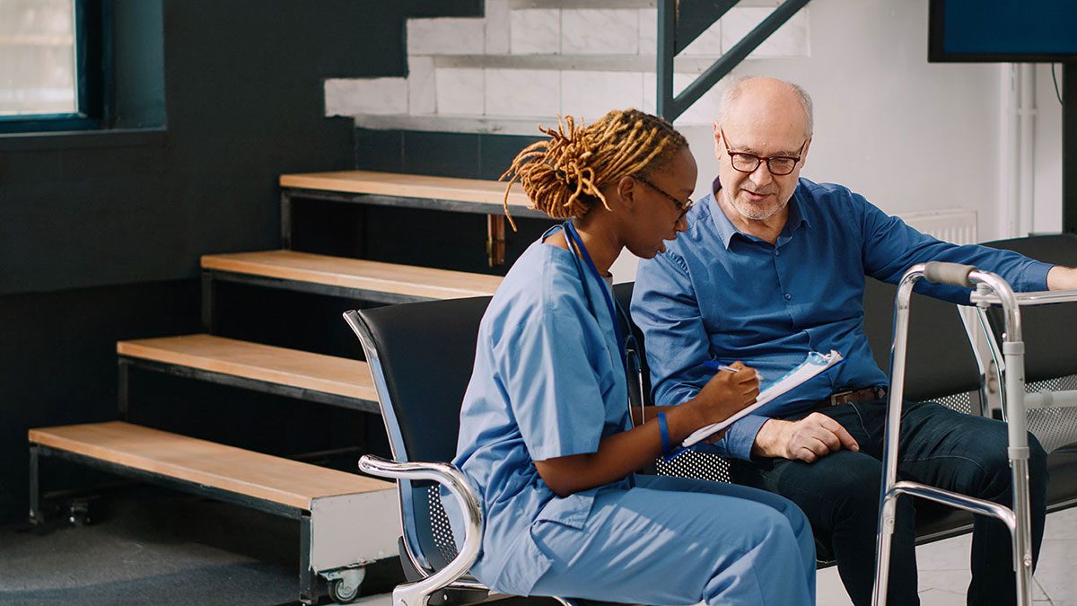 Medic sitting down with patient to discuss results.